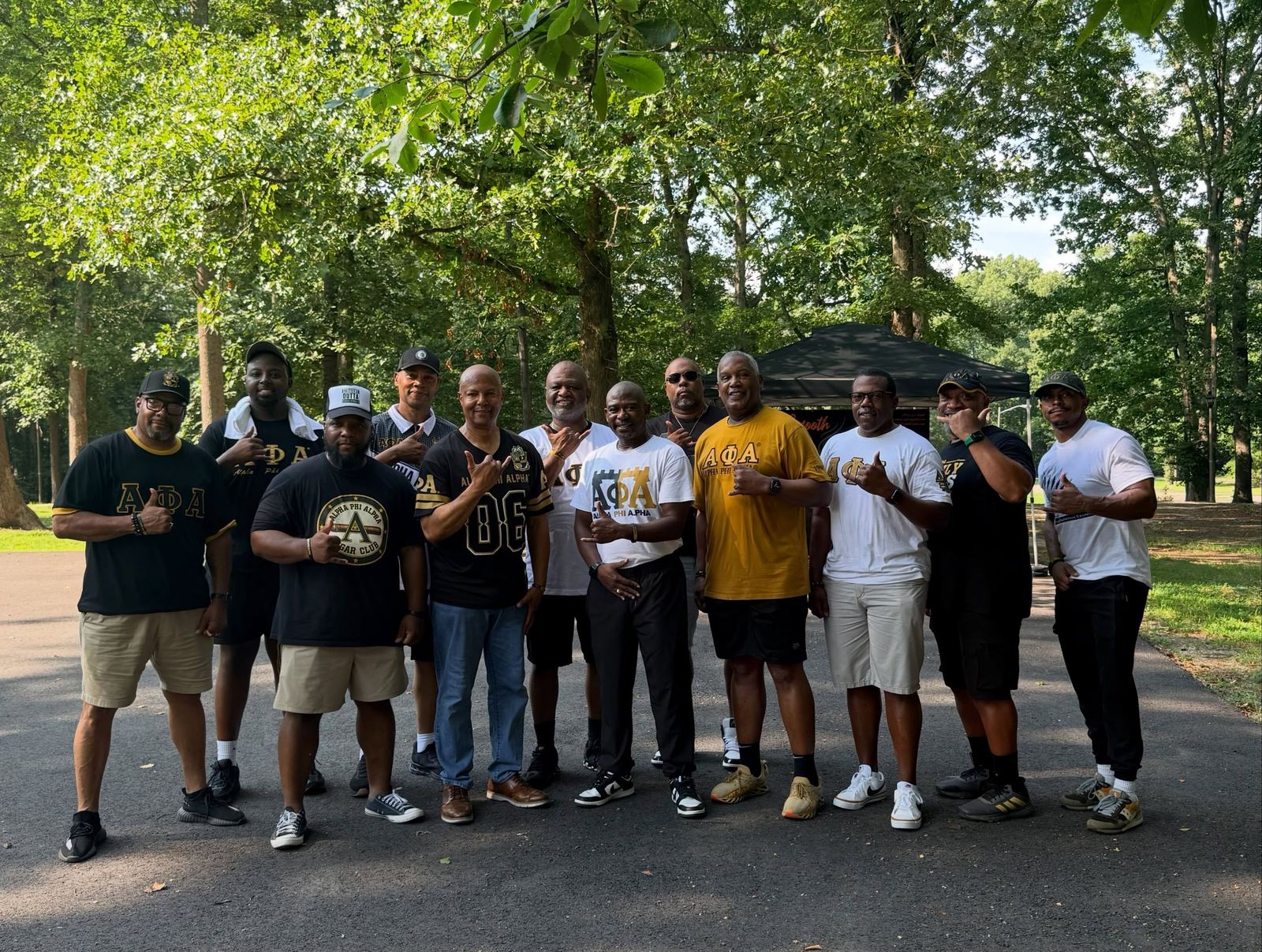 Chapter brothers gathered outdoors under the trees